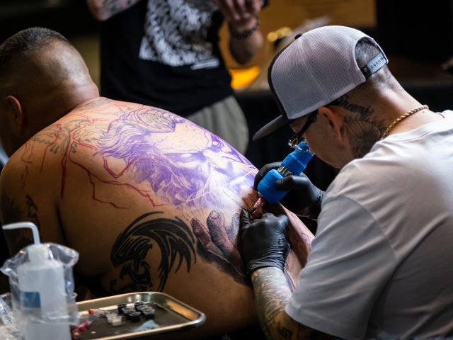 Picture of man getting tattoo.